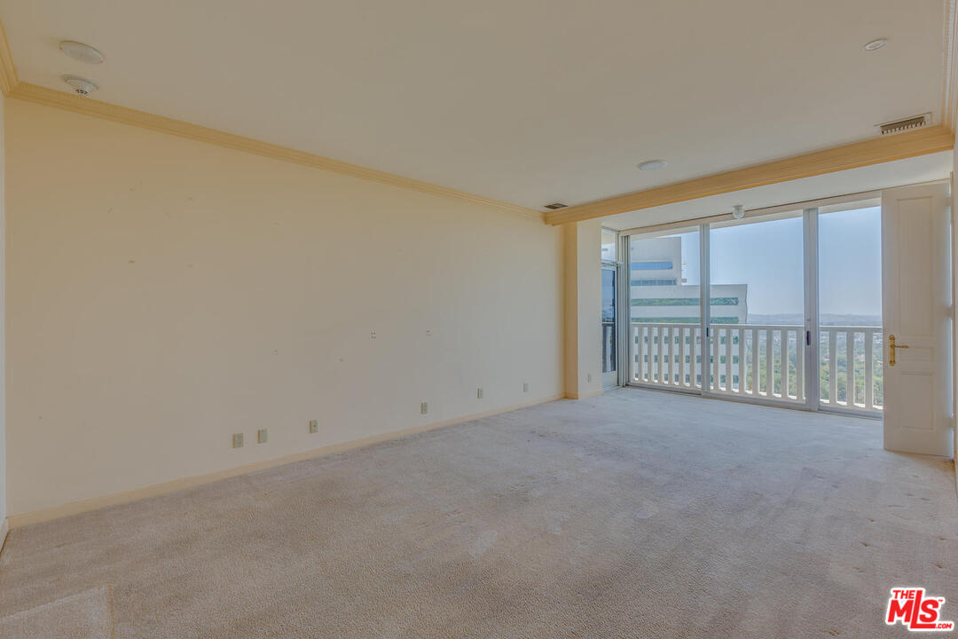 9255 Doheny Road, Unit 902 West Hollywood, CA 90069 - Photo 19 of 47 a view of an empty room with a balcony