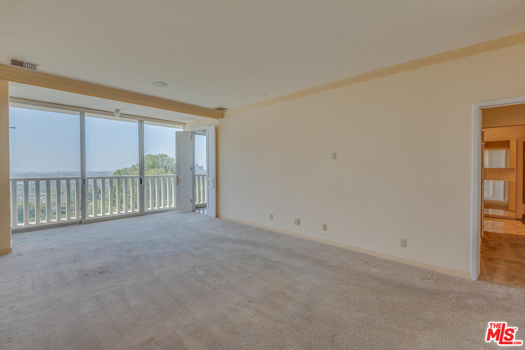 9255 Doheny Road, Unit 902 West Hollywood, CA 90069 - Photo 20 of 47 a view of an empty room with a balcony