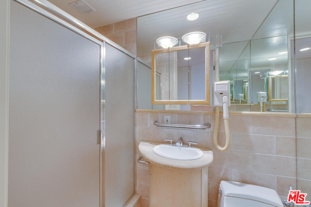 9255 Doheny Road, Unit 902 West Hollywood, CA 90069 - Photo 25 of 47 a bathroom with a sink a toilet and shower