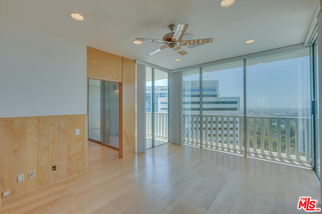 9255 Doheny Road, Unit 902 West Hollywood, CA 90069 - Photo 28 of 47 an empty room with wooden floor and windows