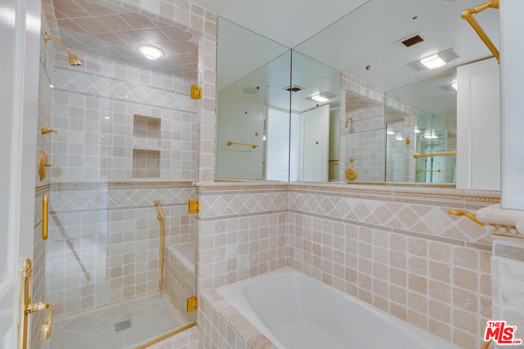 9255 Doheny Road, Unit 902 West Hollywood, CA 90069 - Photo 30 of 47 a bathroom with a shower and a bathtub