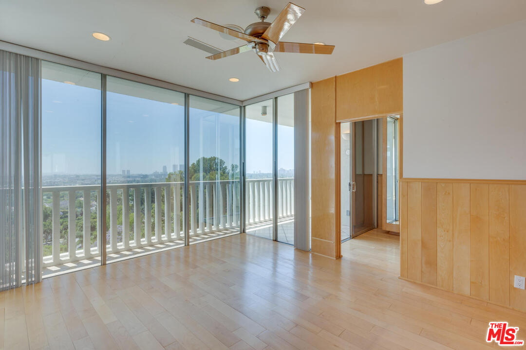 9255 Doheny Road, Unit 902 West Hollywood, CA 90069 - Photo 33 of 47 a view of a room with wooden floor and a ceiling fan