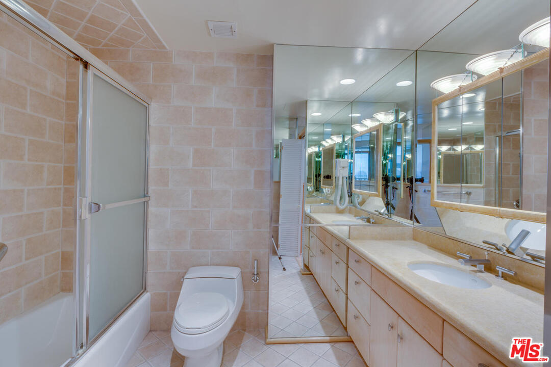9255 Doheny Road, Unit 902 West Hollywood, CA 90069 - Photo 34 of 47 a bathroom with a double vanity sink toilet and shower