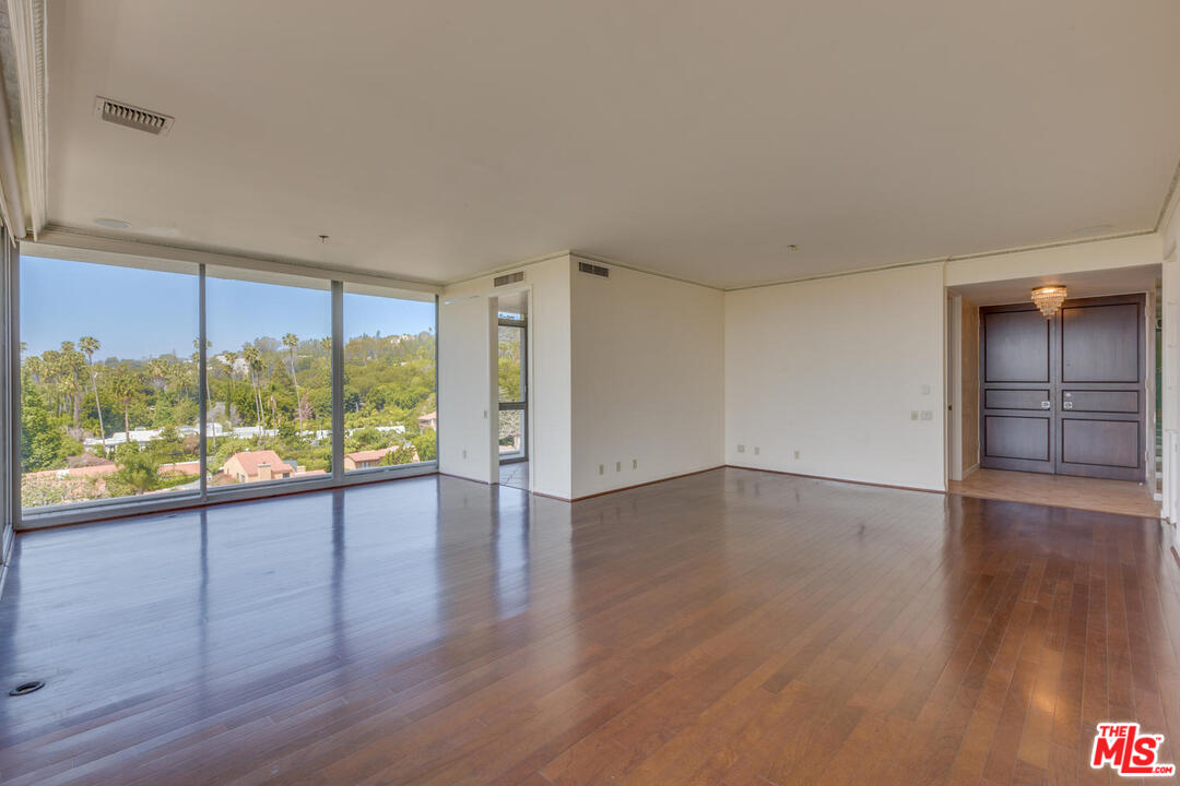 9255 Doheny Road, Unit 902 West Hollywood, CA 90069 - Photo 5 of 47 wooden floor in an empty room with a window
