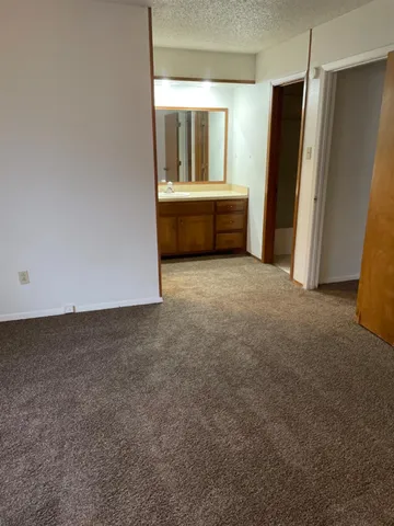 a view of an empty room with a fireplace