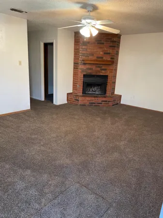a view of empty room with a fireplace