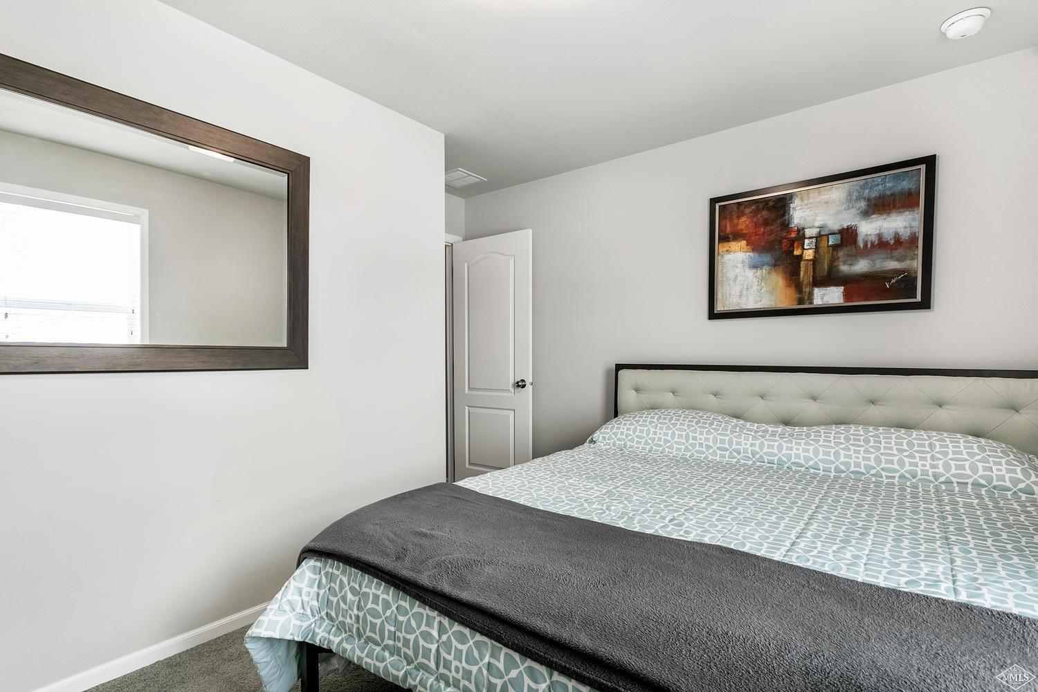 80 Salmon Loop Gypsum, CO 81637 - Photo 15 of 18 a bedroom with a bed and a painting on the wall