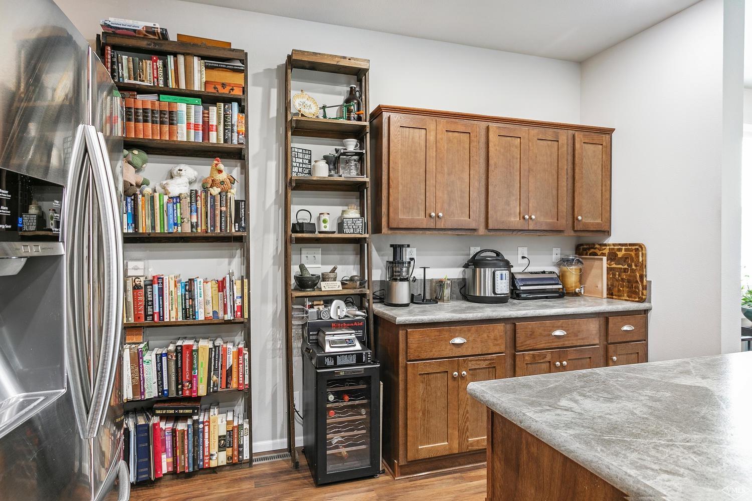 80 Salmon Loop Gypsum, CO 81637 - Photo 9 of 18 a kitchen with stainless steel appliances granite countertop a refrigerator and a wooden cabinets