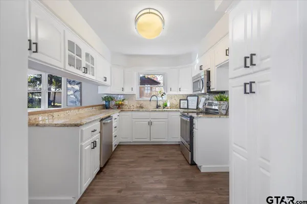 a kitchen with cabinets and window