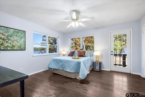 a bedroom with a large bed and a chandelier