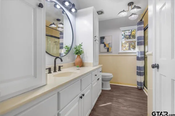 a bathroom with a glass shower door