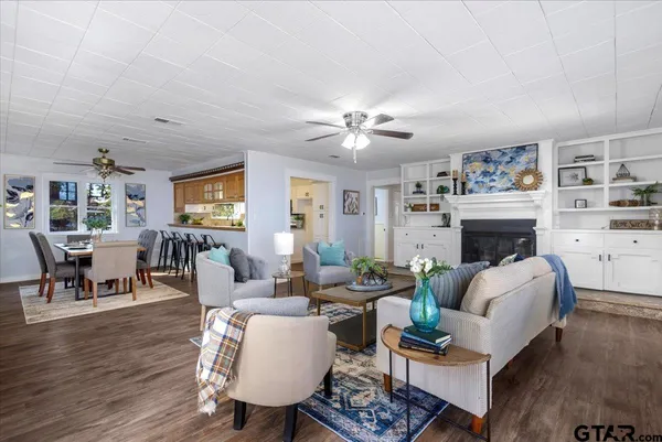 a living room with furniture fireplace and a table