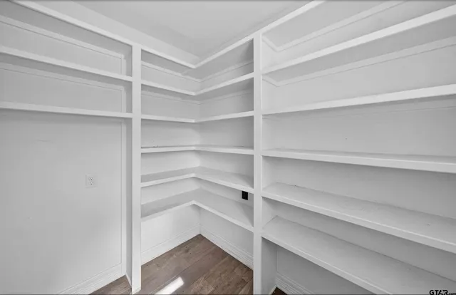 a view of walk in closet with empty racks