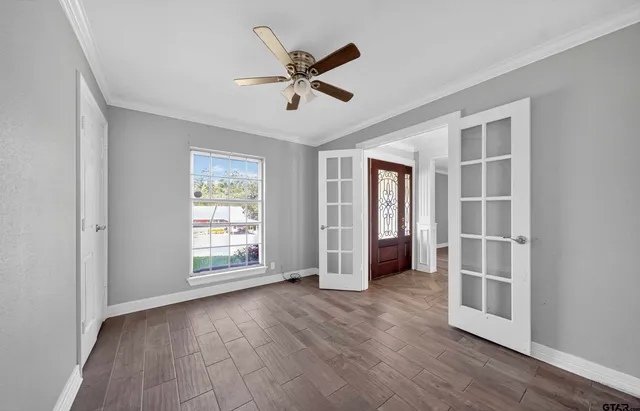 wooden floor in an empty room with a window