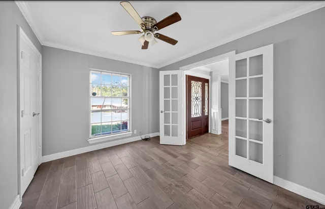 wooden floor in an empty room with a window