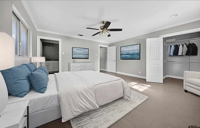 a spacious bedroom with a bed and walk in closet