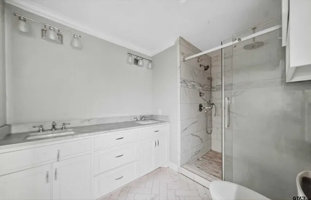 a bathroom with a granite countertop sink a toilet and shower