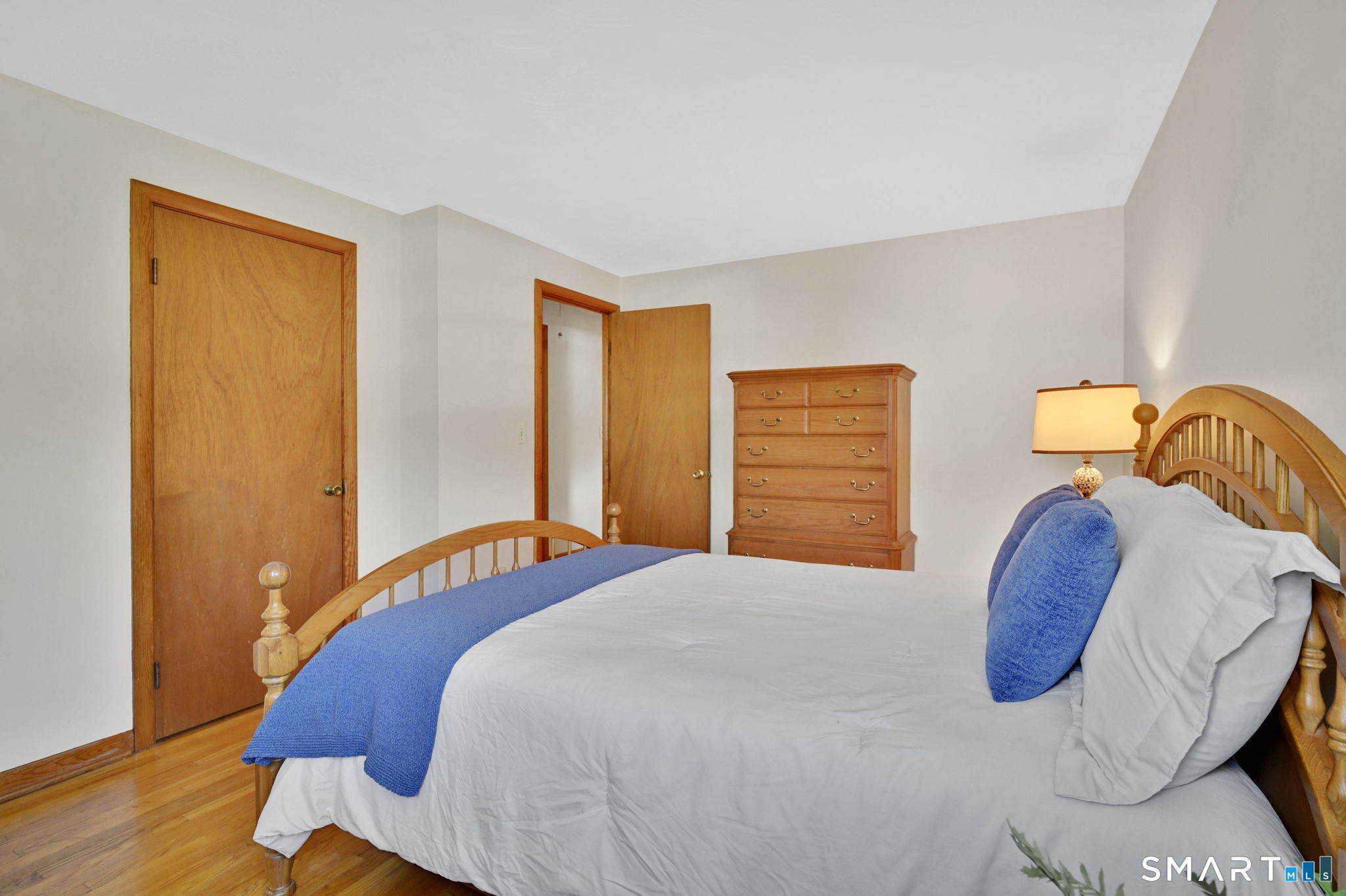 296 Phoenix Street Vernon, CT 06066 - Photo 13 of 34 a bedroom with a bed and wooden floor