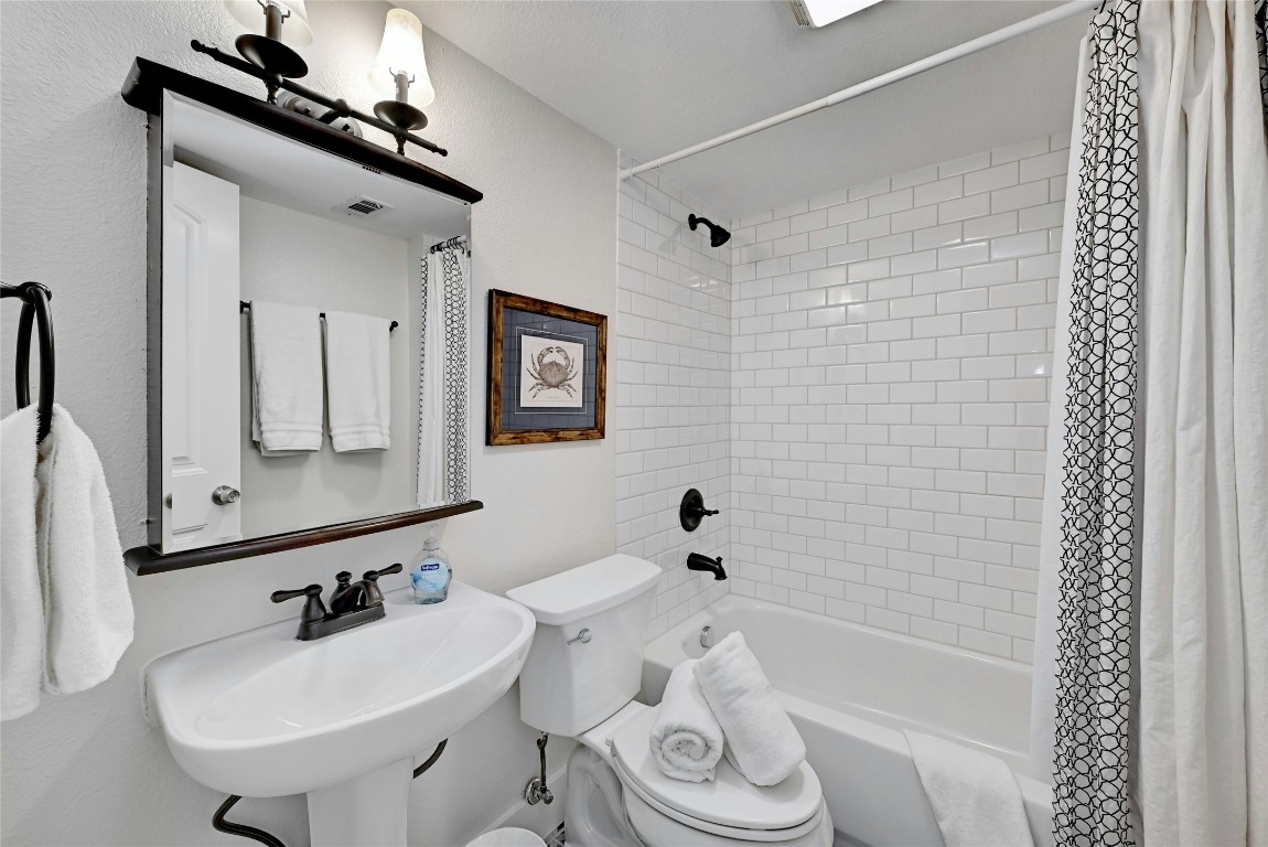 1307 Norwalk Lane, Unit 104 Austin, TX 78703 - Photo 15 of 22 a bathroom with a bathtub a sink and a mirror