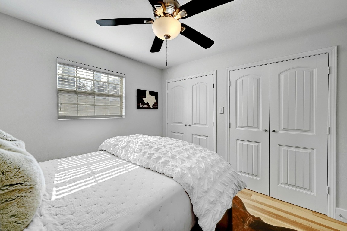 1307 Norwalk Lane, Unit 104 Austin, TX 78703 - Photo 16 of 22 a bedroom with a large bed and a window