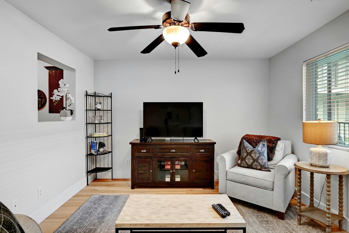 1307 Norwalk Lane, Unit 104 Austin, TX 78703 - Photo 4 of 22 a living room with furniture and a flat screen tv