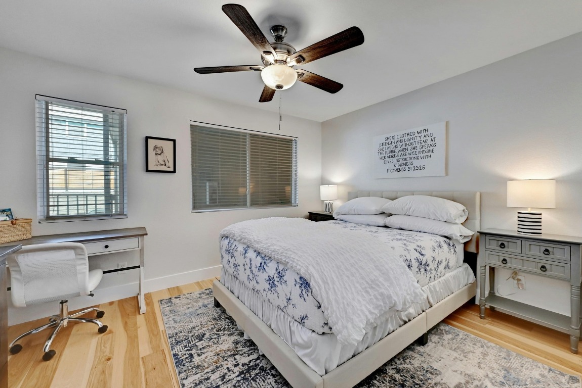 1307 Norwalk Lane, Unit 104 Austin, TX 78703 - Photo 9 of 22 a bedroom with a large bed and a chandelier