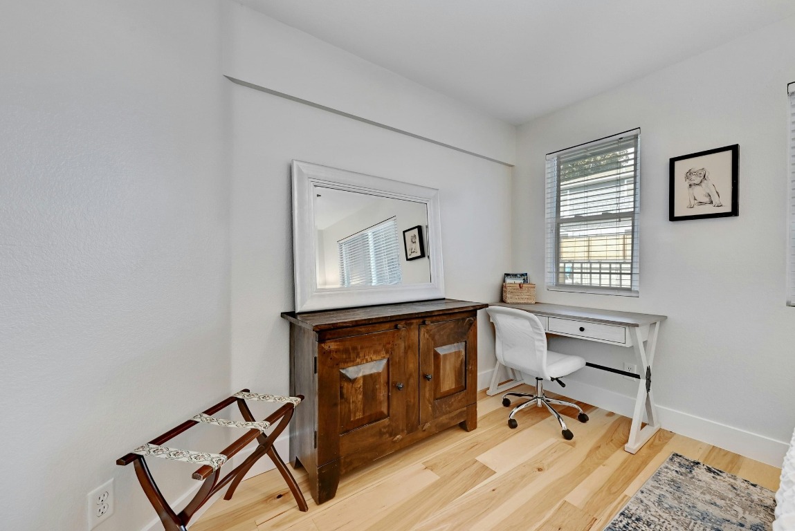 1307 Norwalk Lane, Unit 104 Austin, TX 78703 - Photo 10 of 22 a view of a workspace with furniture and a window