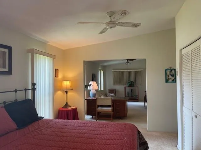 a bedroom with bed and a chandelier