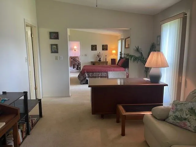a living room with furniture a window and a lamp