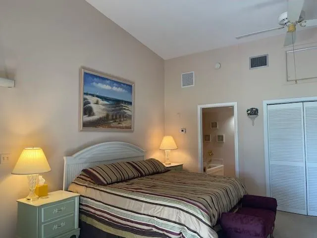 a bedroom with a bed and lamp