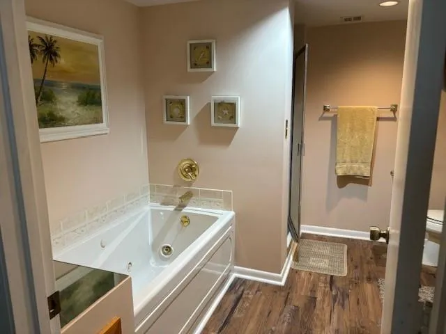 a bathroom with a tub and shower