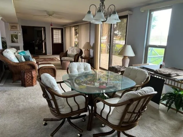 a view of a dining room with furniture window and outside view