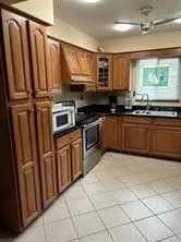 a kitchen with stainless steel appliances granite countertop a refrigerator and a sink
