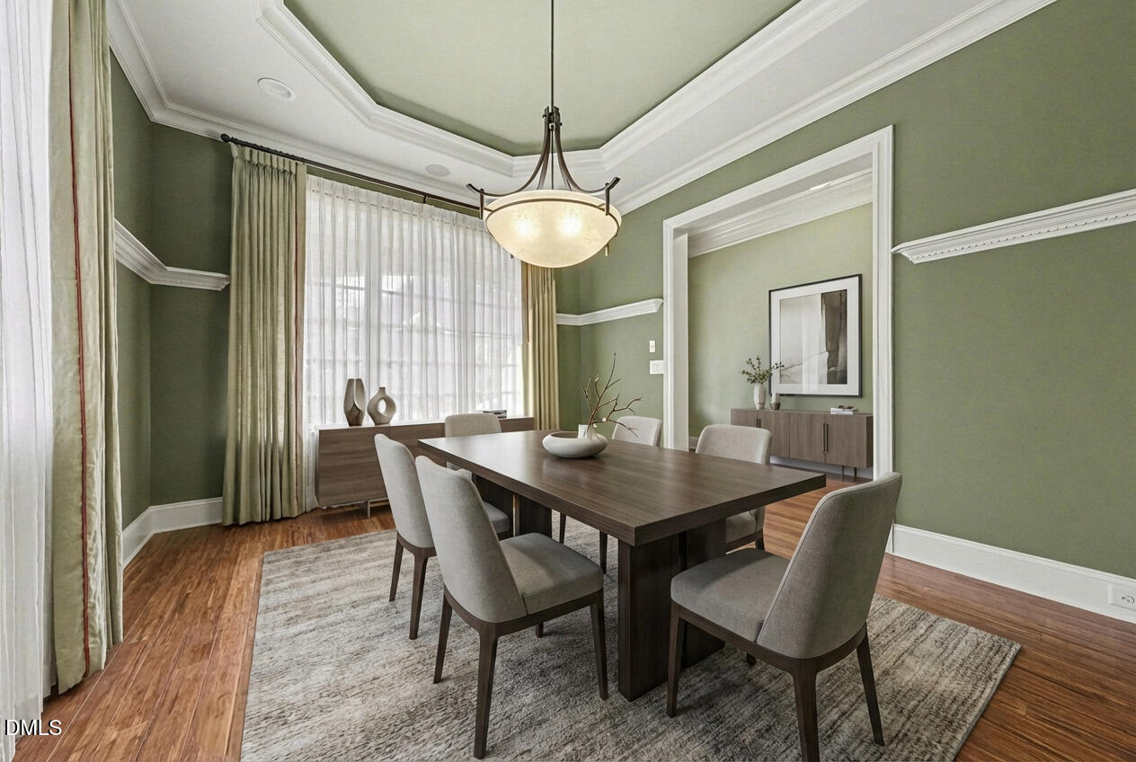 4105 Gardenlake Drive Raleigh, NC 27612 - Photo 11 of 28 a dining room with furniture a chandelier and wooden floor
