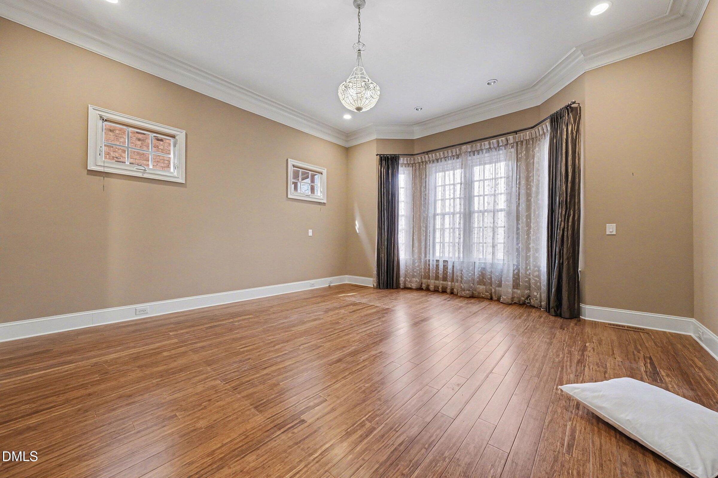 4105 Gardenlake Drive Raleigh, NC 27612 - Photo 12 of 28 a view of an empty room with glass door and wooden floor
