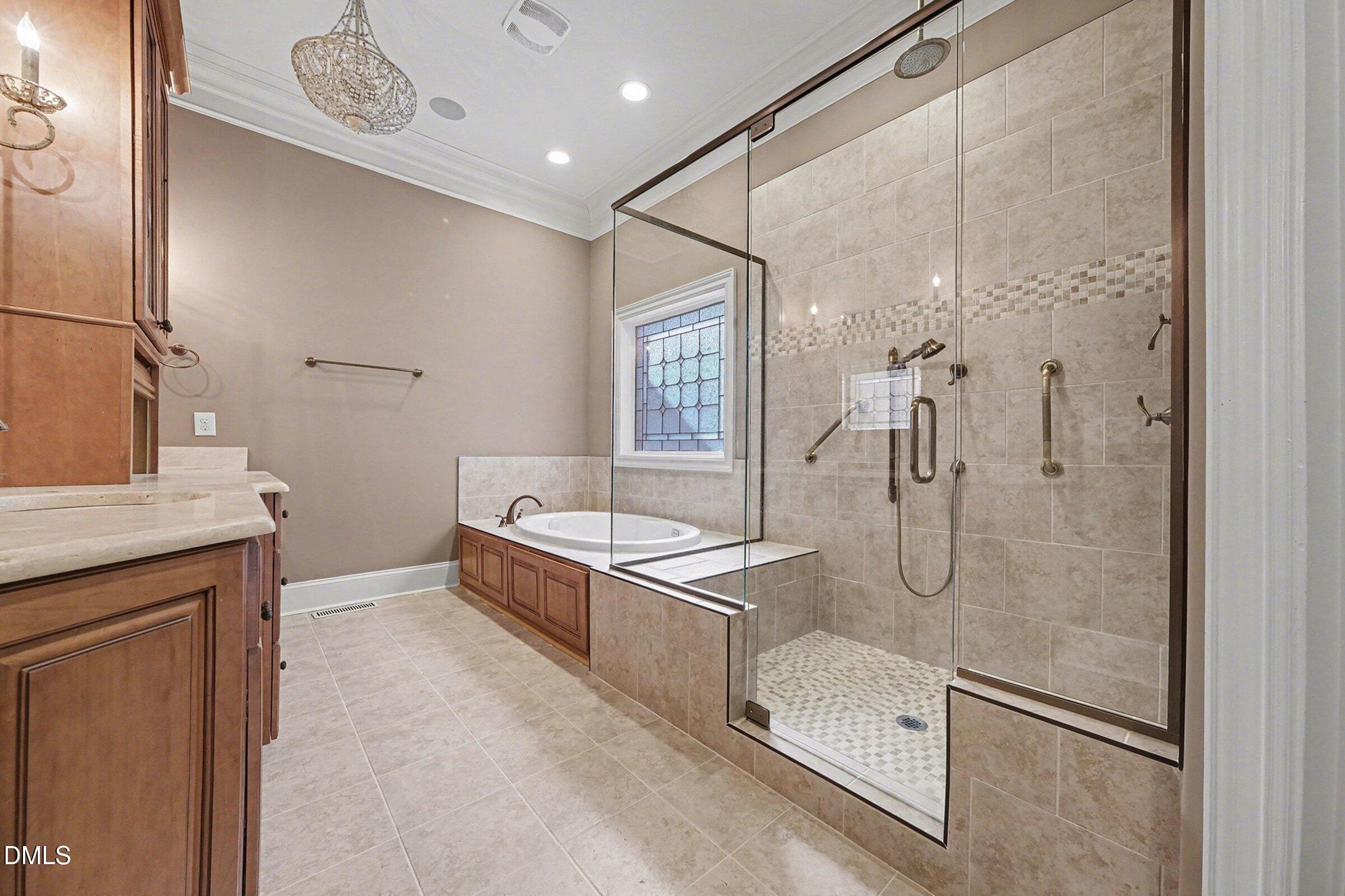 4105 Gardenlake Drive Raleigh, NC 27612 - Photo 17 of 28 a bathroom with a granite countertop sink a toilet a mirror and shower