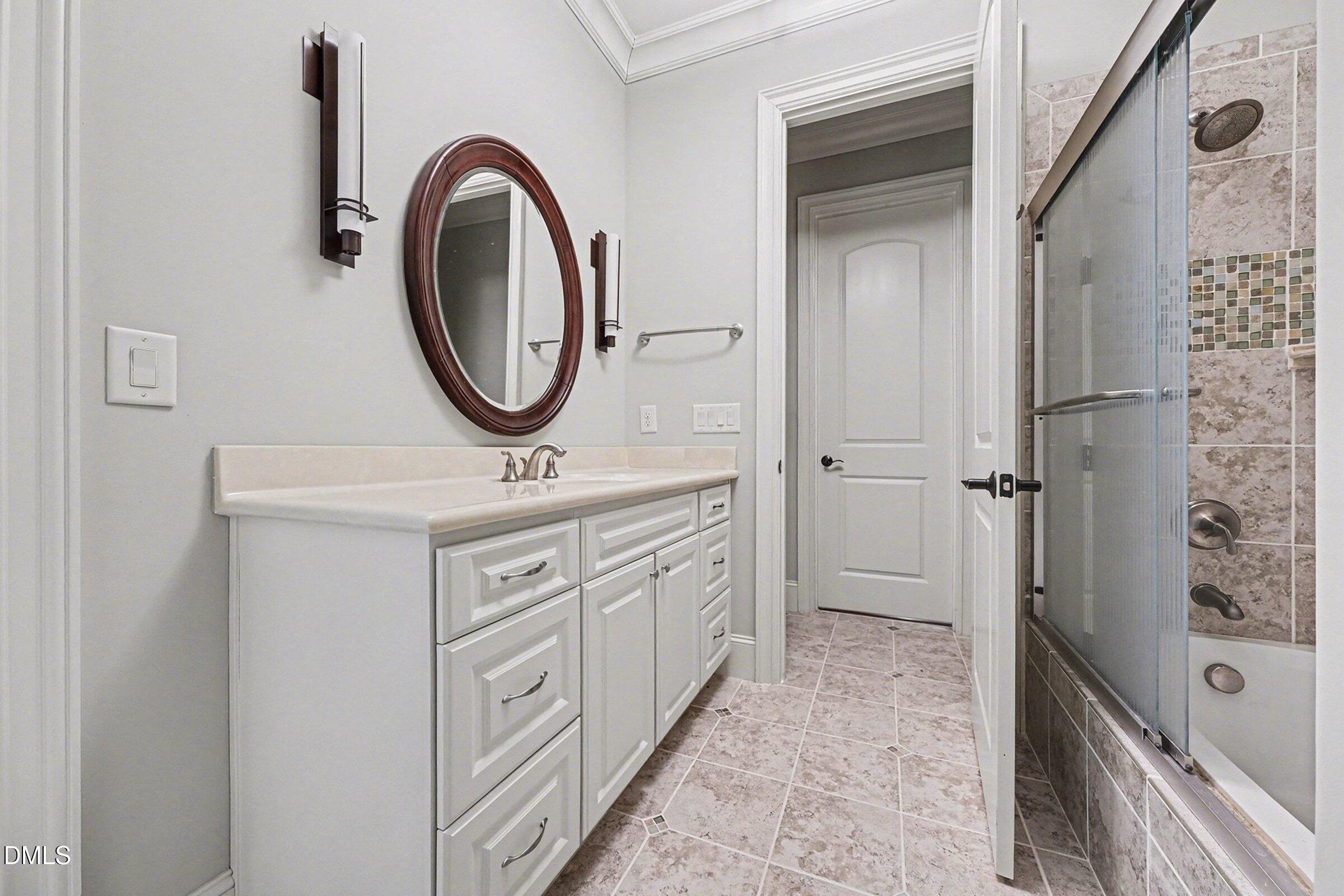 4105 Gardenlake Drive Raleigh, NC 27612 - Photo 19 of 28 a bathroom with a double vanity sink a mirror and shower
