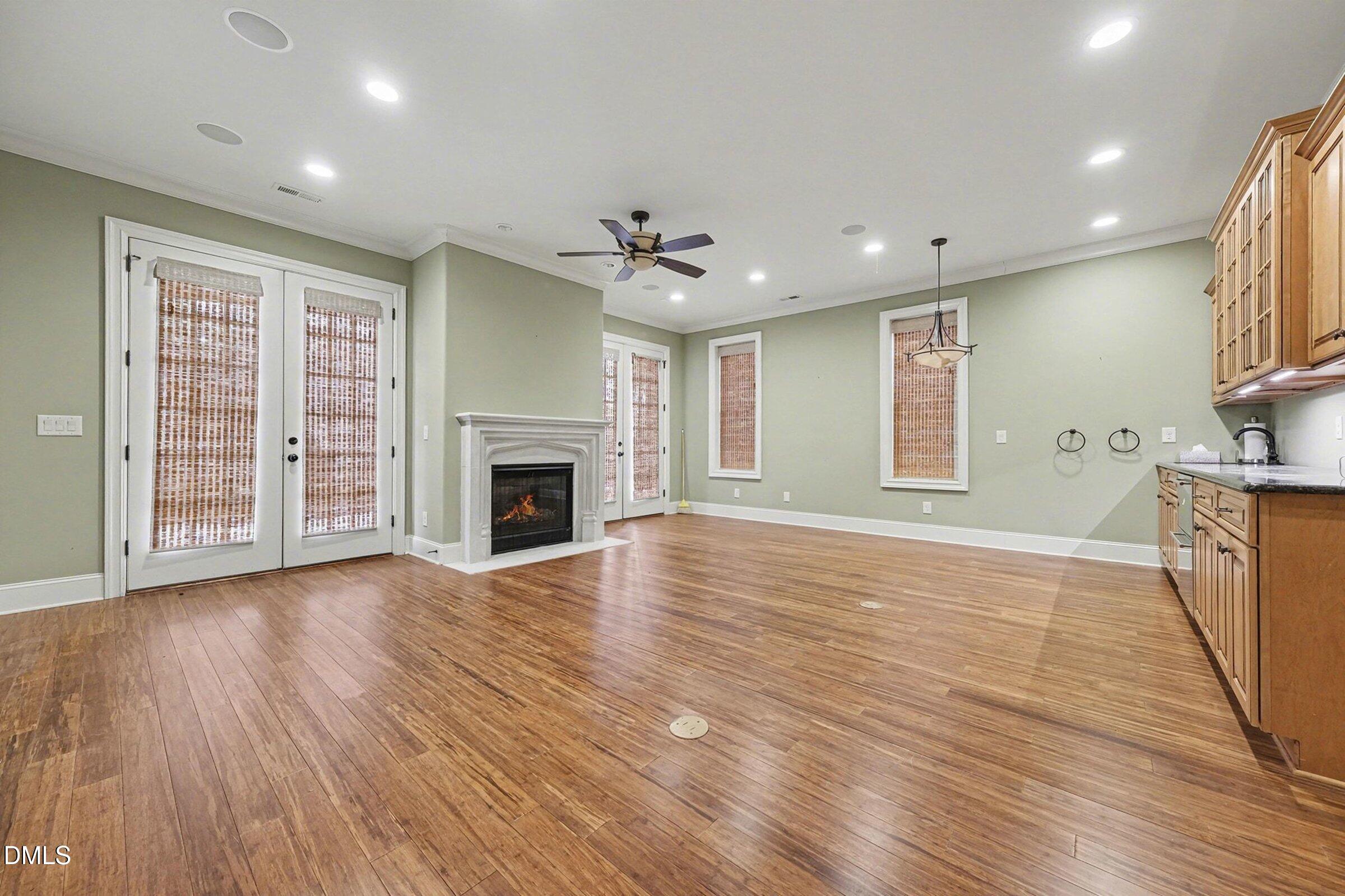 4105 Gardenlake Drive Raleigh, NC 27612 - Photo 20 of 28 an empty room with wooden floor fireplace and windows
