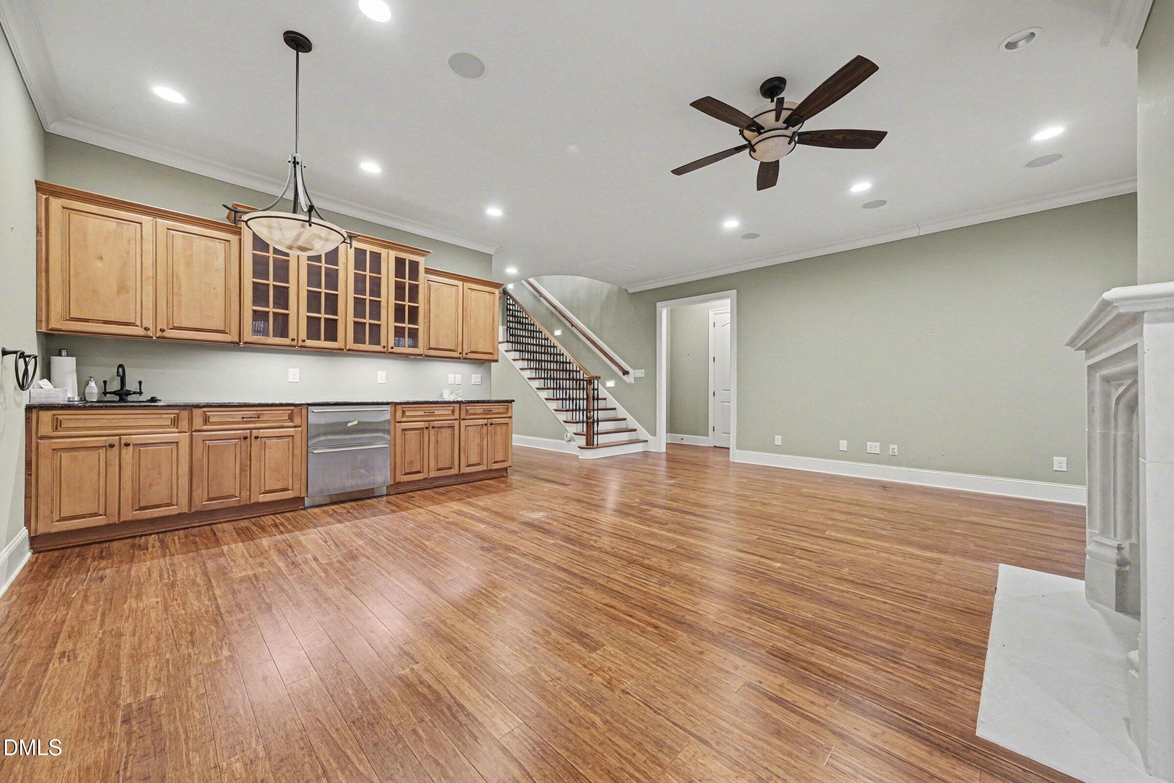 4105 Gardenlake Drive Raleigh, NC 27612 - Photo 21 of 28 a kitchen with stainless steel appliances granite countertop a sink a stove a refrigerator and island with wooden floors
