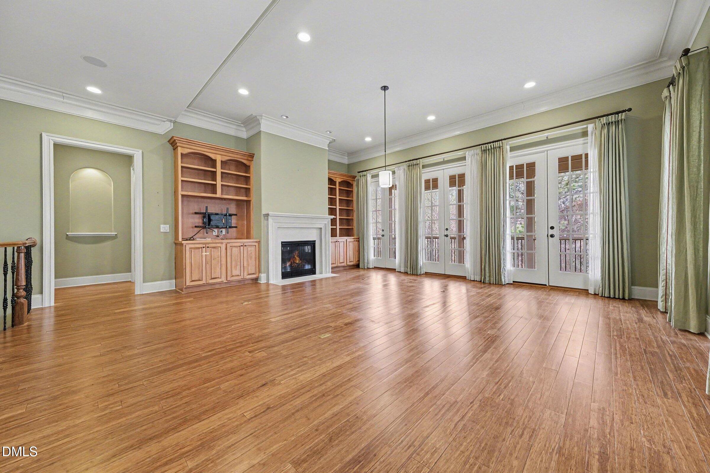 4105 Gardenlake Drive Raleigh, NC 27612 - Photo 22 of 28 a view of an empty room with window and wooden floor