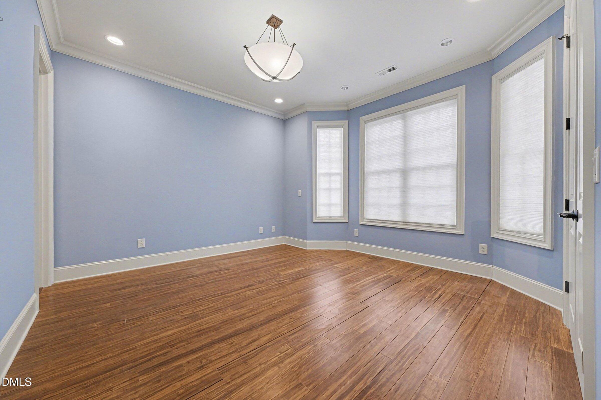 4105 Gardenlake Drive Raleigh, NC 27612 - Photo 24 of 28 wooden floor in an empty room with a window