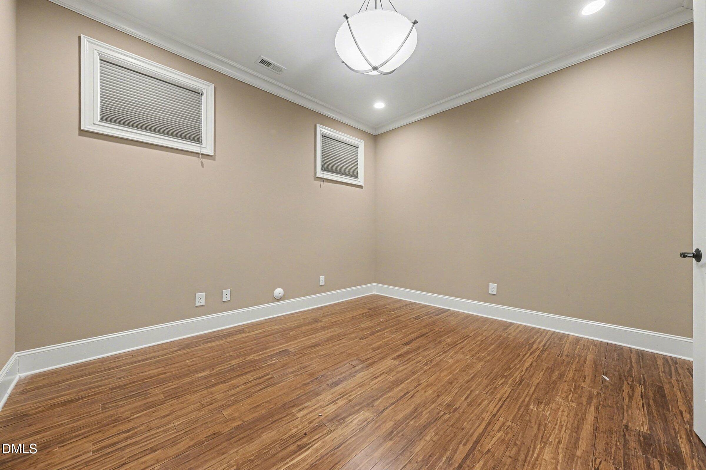 4105 Gardenlake Drive Raleigh, NC 27612 - Photo 25 of 28 an empty room with wooden floor and windows