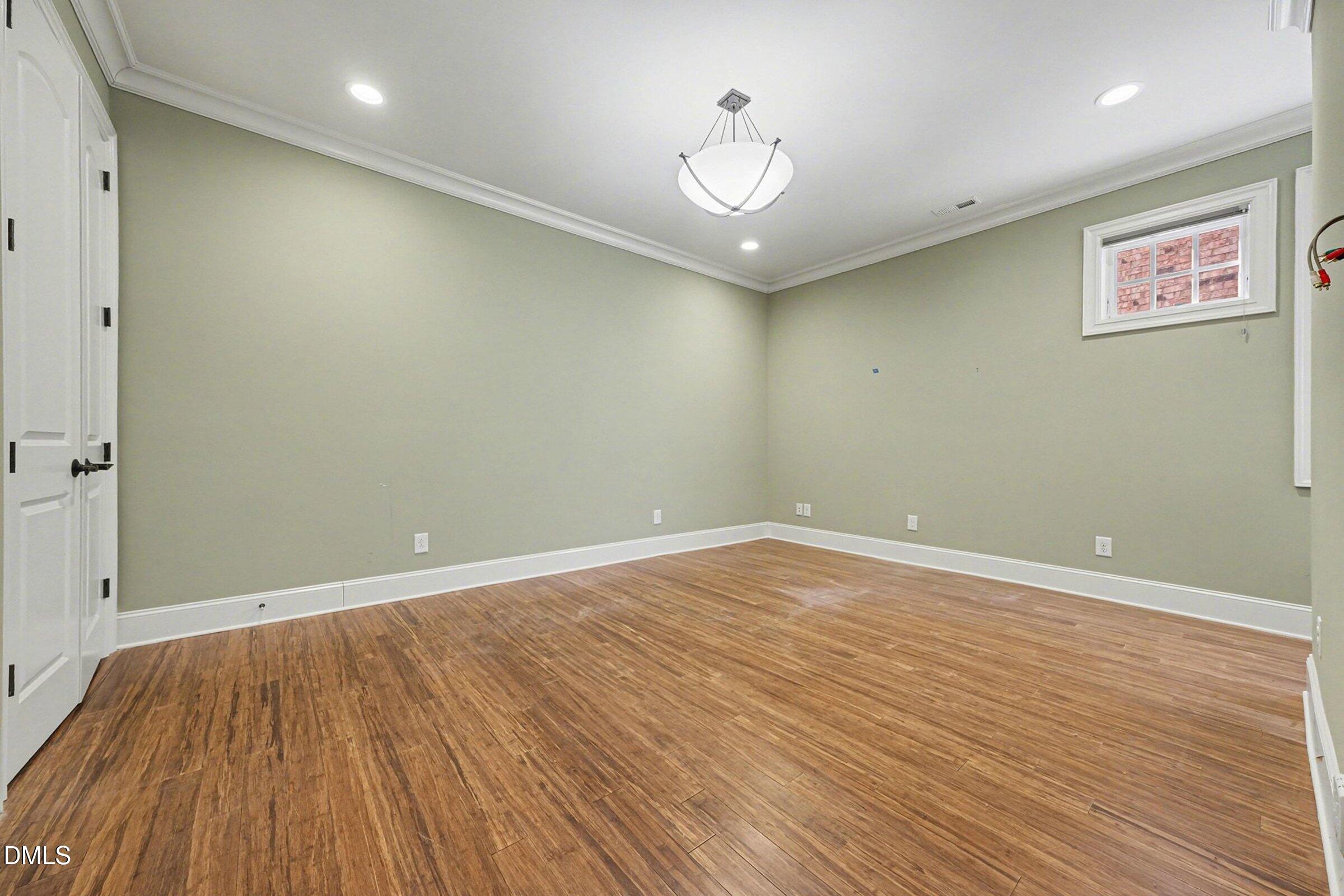 4105 Gardenlake Drive Raleigh, NC 27612 - Photo 26 of 28 an empty room with wooden floor and windows