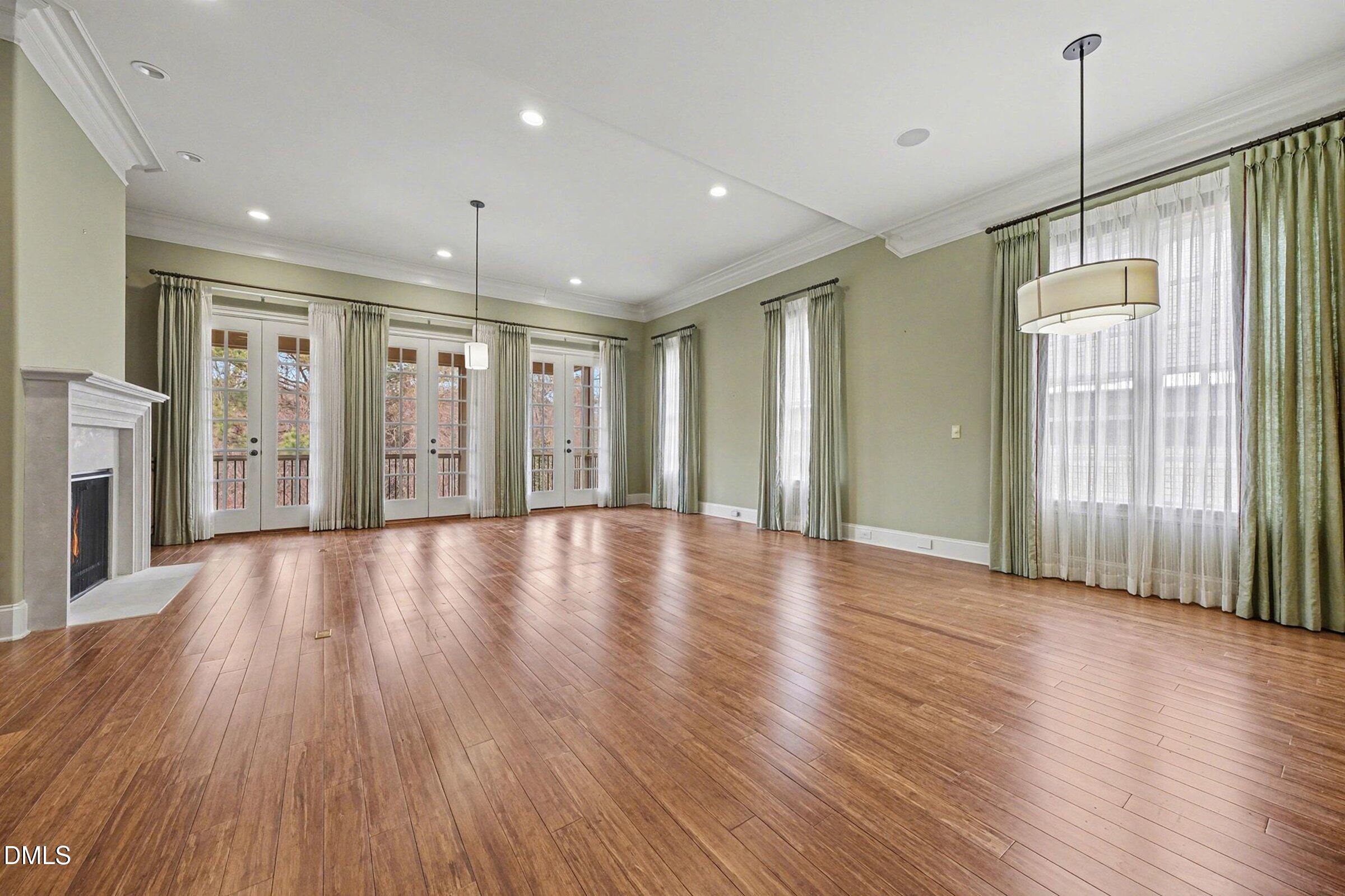 4105 Gardenlake Drive Raleigh, NC 27612 - Photo 4 of 28 a view of an empty room with wooden floor and a window