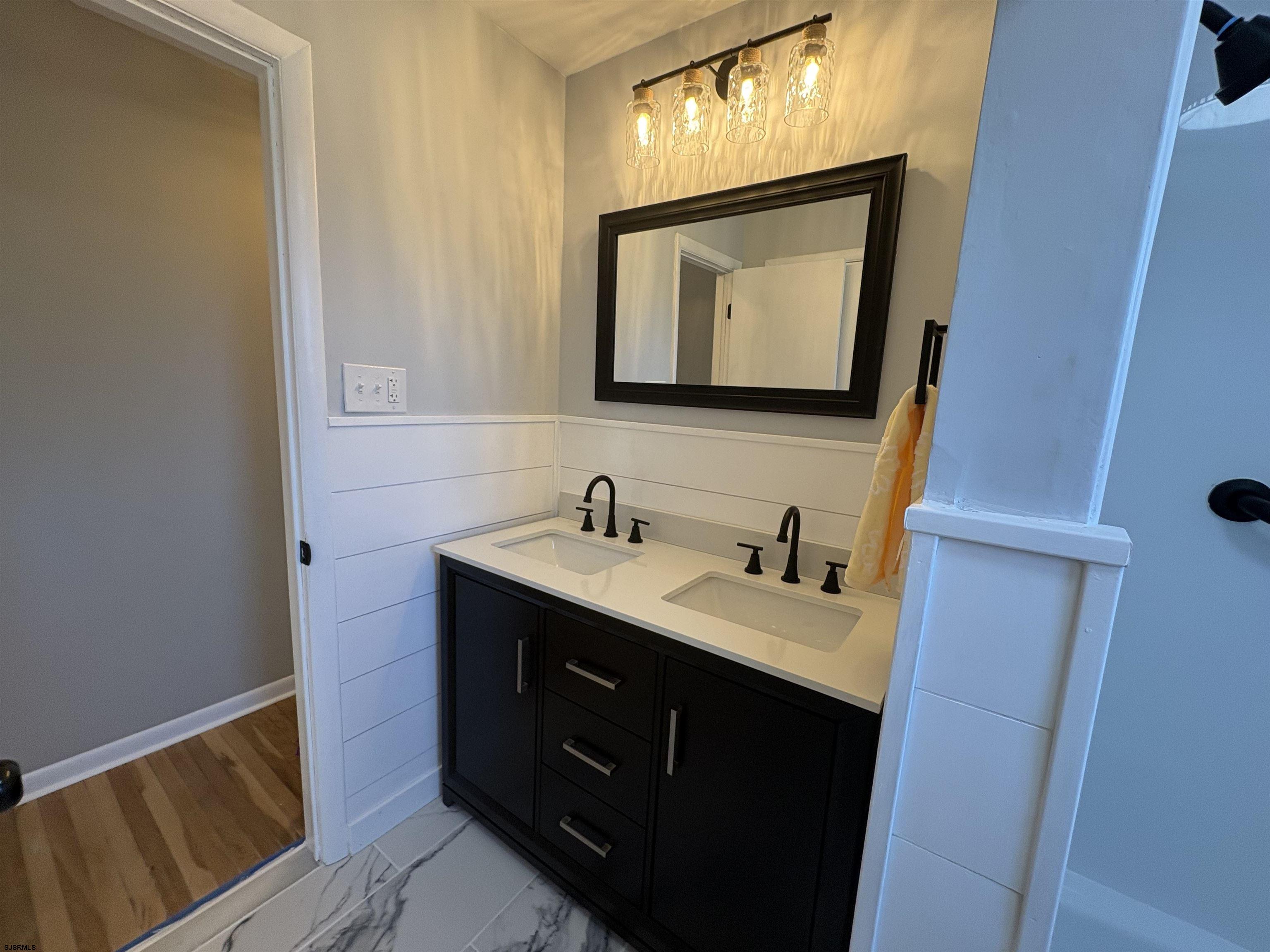 31 Gulph Mill Road Somers Point, NJ 08244 - Photo 11 of 32 a bathroom with a toilet sink and mirror