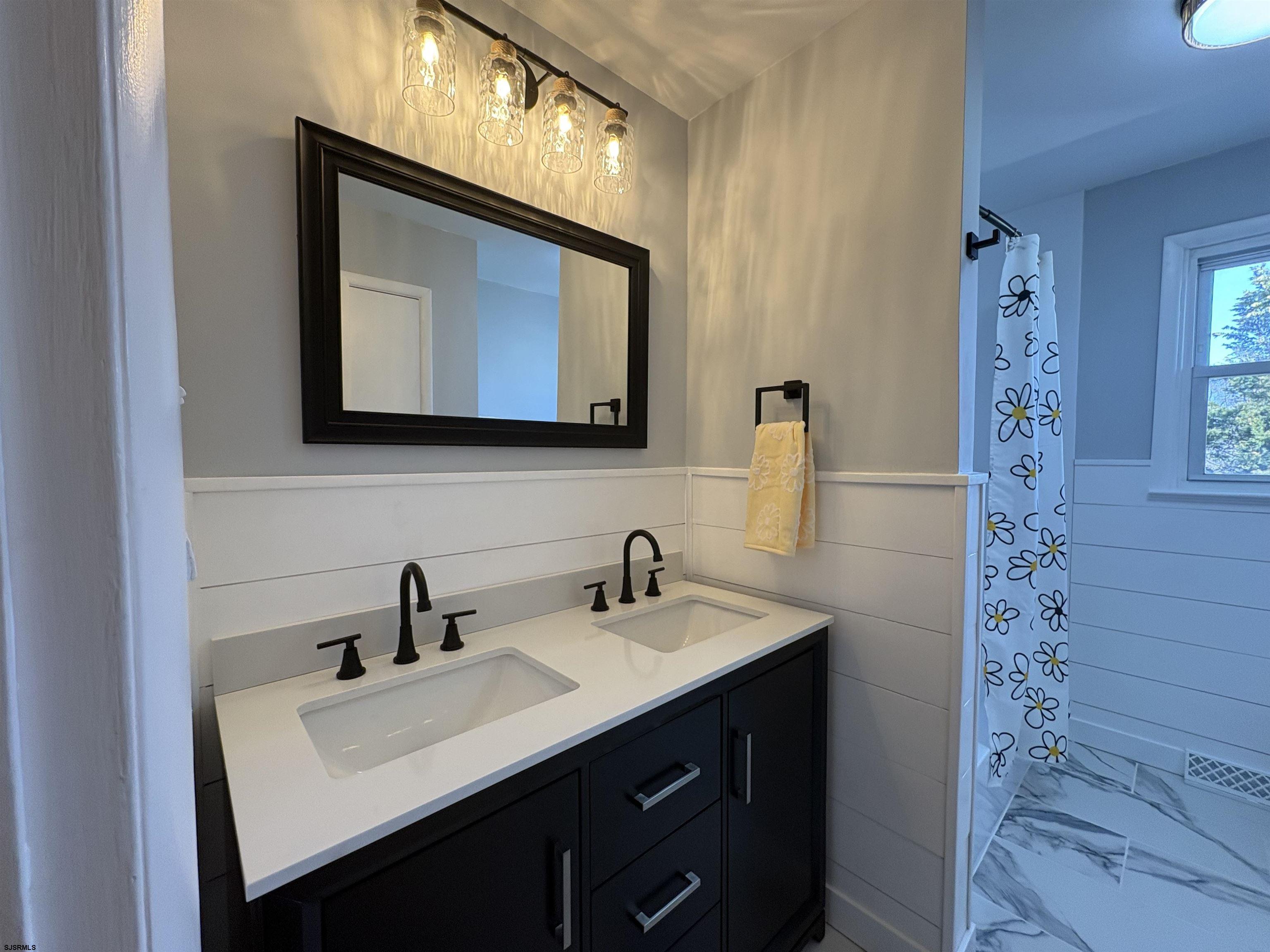 31 Gulph Mill Road Somers Point, NJ 08244 - Photo 12 of 32 a bathroom with a sink vanity and mirror