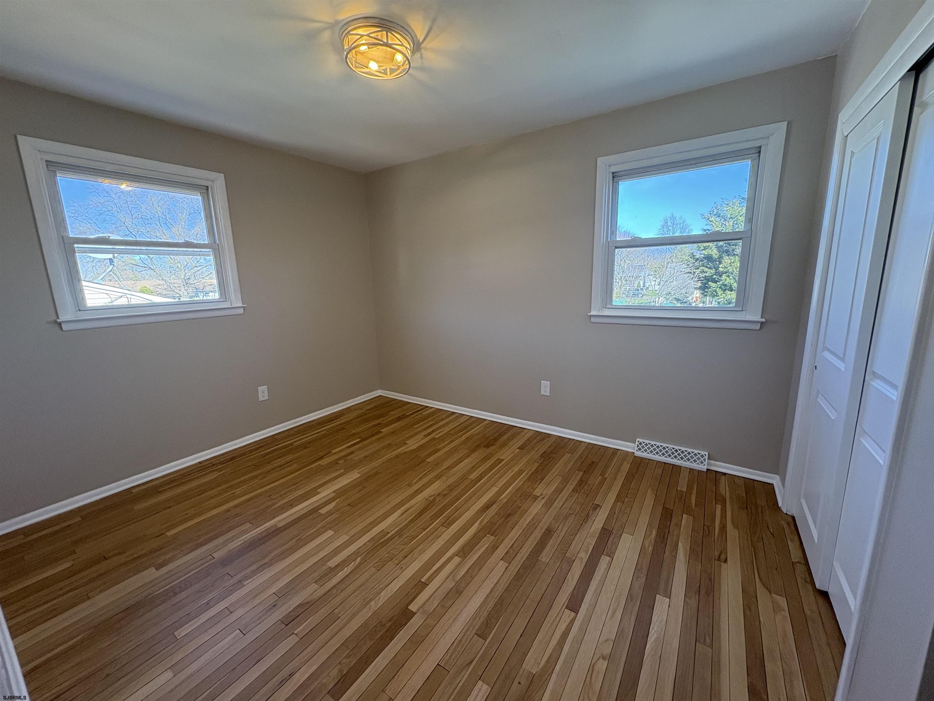 31 Gulph Mill Road Somers Point, NJ 08244 - Photo 14 of 32 a view of an empty room with wooden floor and a window