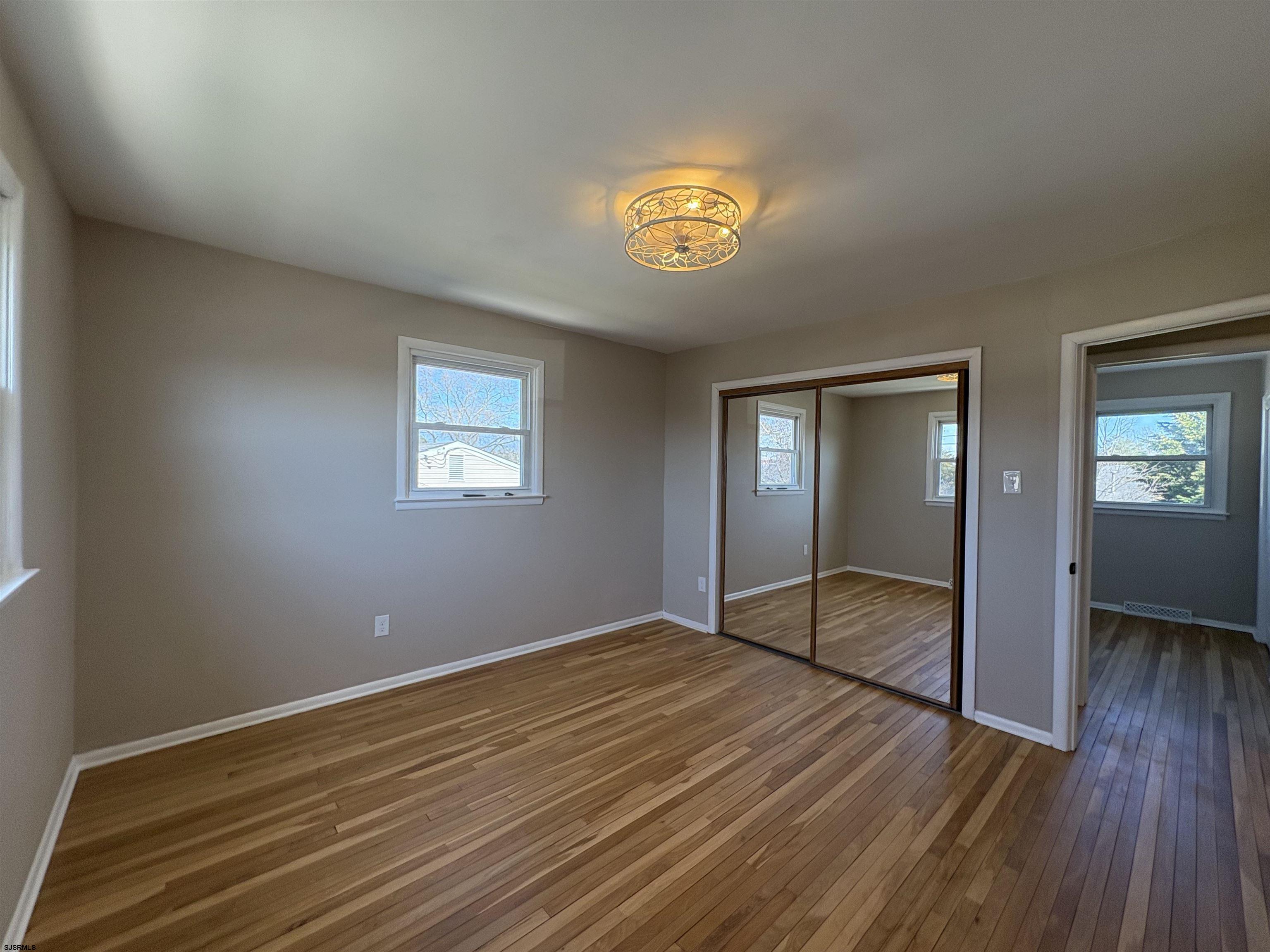 31 Gulph Mill Road Somers Point, NJ 08244 - Photo 15 of 32 wooden floor in an empty room with a window