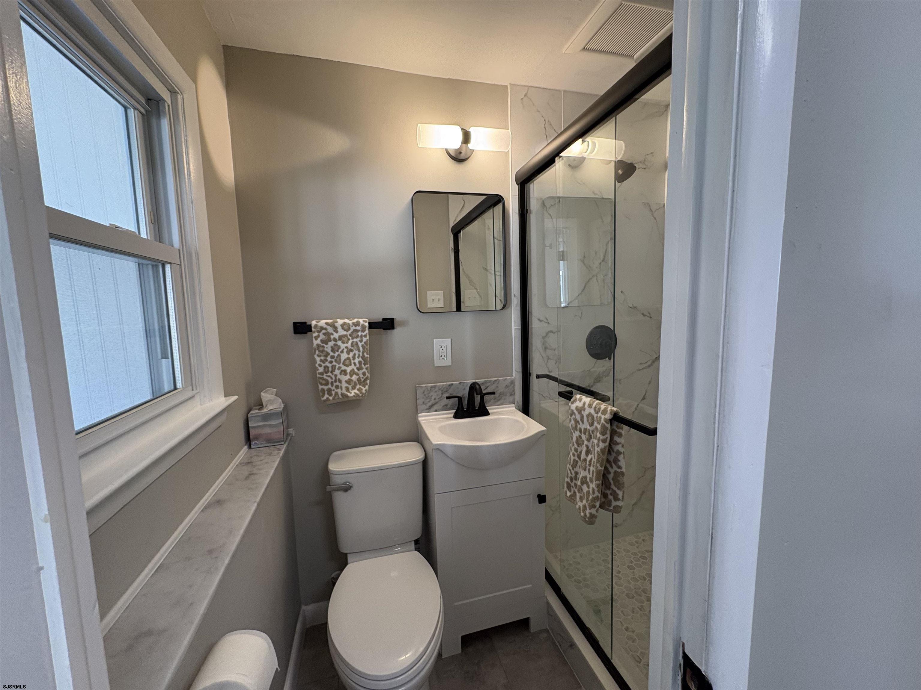 31 Gulph Mill Road Somers Point, NJ 08244 - Photo 24 of 32 a bathroom with a toilet a sink and shower