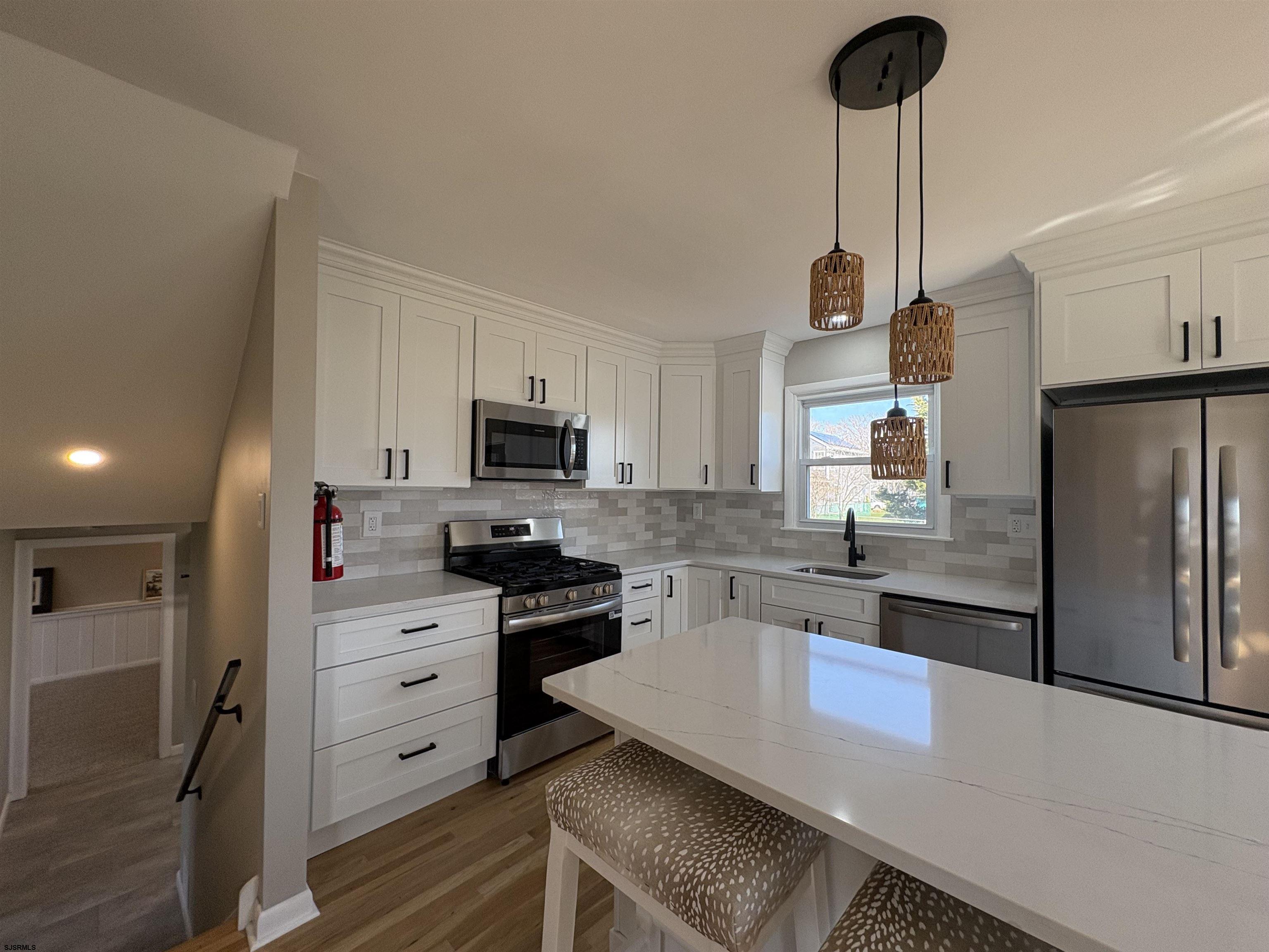 31 Gulph Mill Road Somers Point, NJ 08244 - Photo 5 of 32 a kitchen with stainless steel appliances a stove a sink and a refrigerator